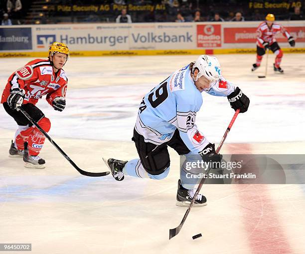 Alexander Barta of Hamburg is challenged by Christoph Gawlik of Frankfurt during the DEL match between Hamburg Freezers and Frankfurt Lions at the...