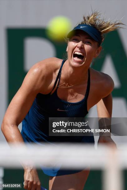 Russia's Maria Sharapova serves to Croatia's Donna Vekic during their women's singles second round match on day five of The Roland Garros 2018 French...