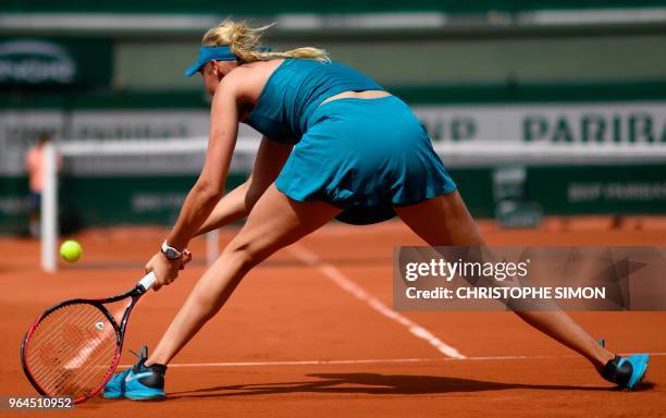 Croatia's Donna Vekic plays a backhand return to Russia's Maria Sharapova during their women's singles second round match on day five of The Roland...