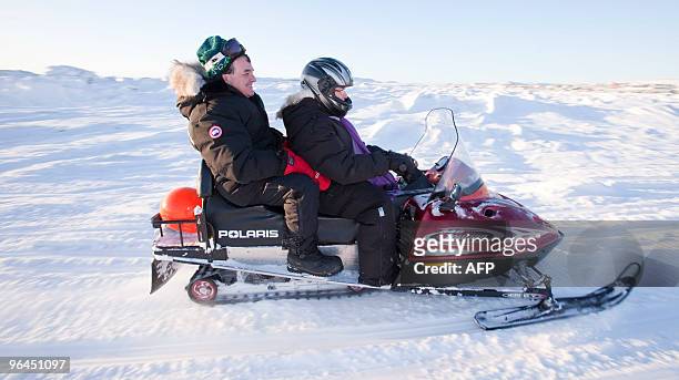 Canada's Finance Minister Jim Flaherty goes for a snowmobile ride in Iqaluit, Nunavut, Canada, February 5, 2010 as Canada plays host to the G7...