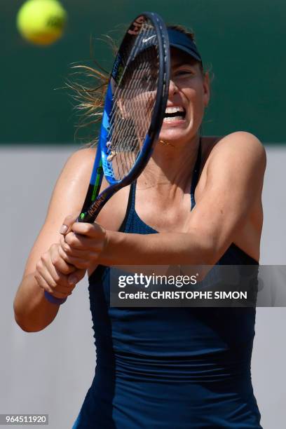 Russia's Maria Sharapova plays a backhand return to Croatia's Donna Vekic during their women's singles second round match on day five of The Roland...