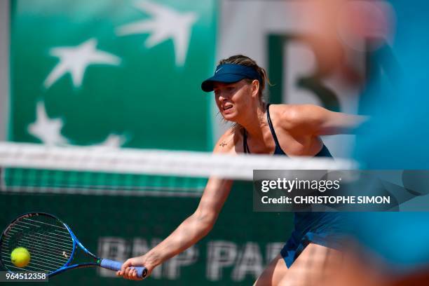 Russia's Maria Sharapova plays a forehand return to Croatia's Donna Vekic during their women's singles second round match on day five of The Roland...