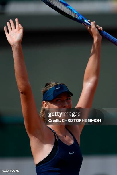 Russia's Maria Sharapova celebrates after victory over Croatia's Donna Vekic during their women's singles second round match on day five of The...