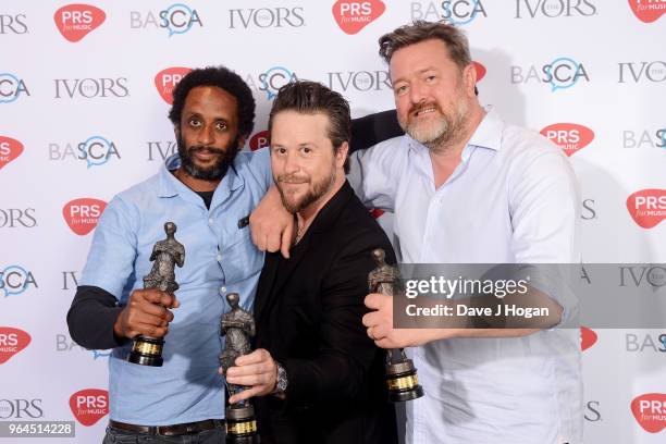 Pete Turner, Mark Potter and Guy Garvey of Elbow with the award for Best Song Musically and Lyrically, pose in the winner's room during the Ivor...