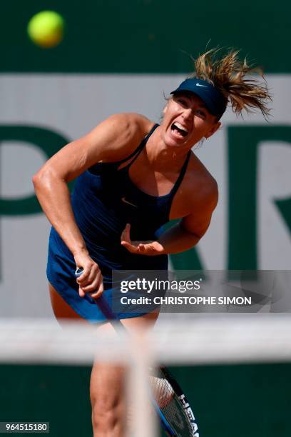 Russia's Maria Sharapova serves to Croatia's Donna Vekic during their women's singles second round match on day five of The Roland Garros 2018 French...