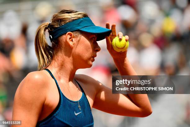 Russia's Maria Sharapova walks on court as she prepares to serve to Croatia's Donna Vekic during their women's singles second round match on day five...