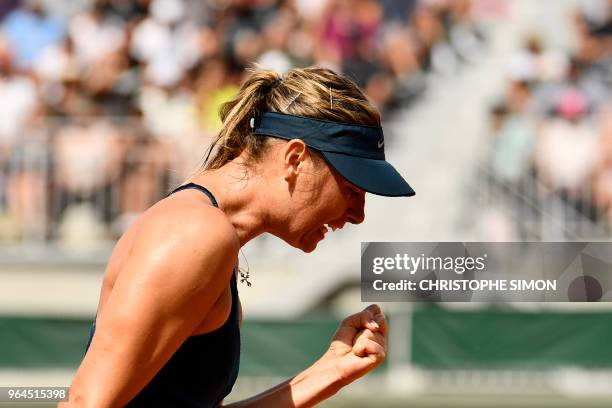 Russia's Maria Sharapova reacts after a point against Croatia's Donna Vekic during their women's singles second round match on day five of The Roland...