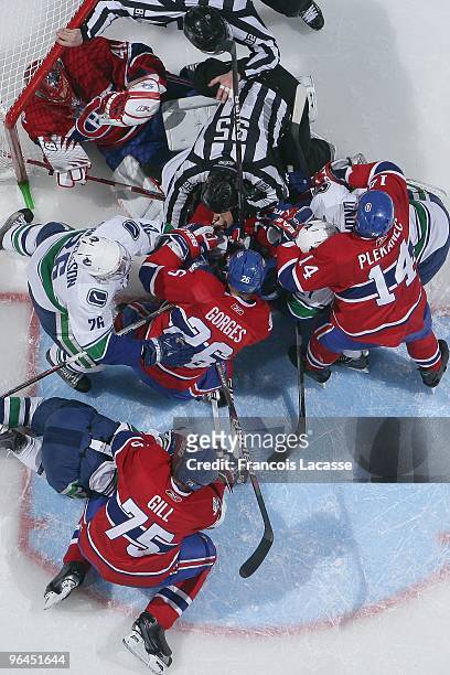 Players piles up in Jaroslav Halak of the Montreal Canadiens net during the NHL game against the Vancouver Canucks on February 2, 2010 at the Bell...