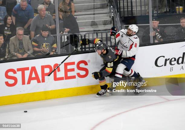 Vegas Golden Knights defenseman Nate Schmidt and Washington Capitals left wing Alex Ovechkin battle for control of the puck during the second period...