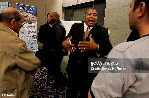 Job agent Cordell Taylor, with Zurdita Corp. Speaks with a job seeker during a career fair at the Convention Center on February 5, 2010in San Diego,...