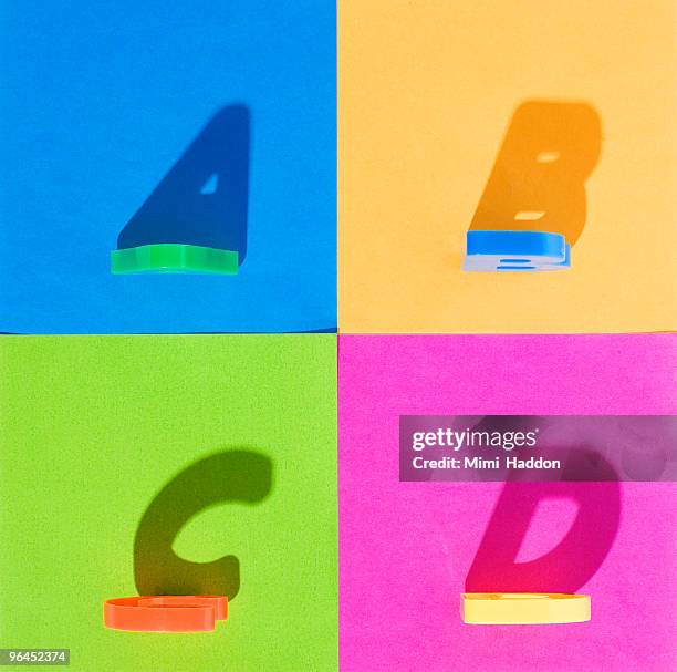 alphabet letters casting strong shadows on paper - bokstavsmagnet bildbanksfoton och bilder