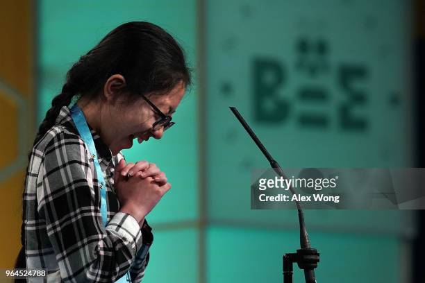 Lauren Guo of Westminster, Colorado, reacts as she tries to spell her word during round four of the 91st Scripps National Spelling Bee at the Gaylord...