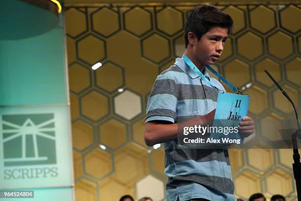 Jacob Faulk of Denver, Colorado, tries to spell his word during round four of the 91st Scripps National Spelling Bee at the Gaylord National Resort...