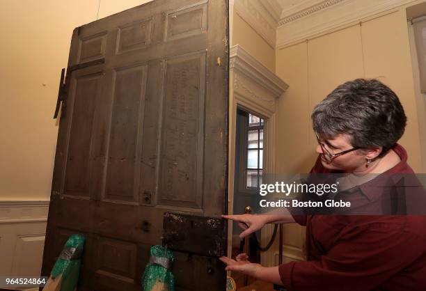 North Bennet Street School preservation carpenter Angela Larimer points out the original lock on John Hancock's door, which will be displayed at...