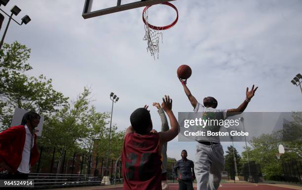 Walter James takes a rebound while playing basketball during the Real Kidz Boston program at the Mildred C. Hailey Apartments in the Jamaica Plain...