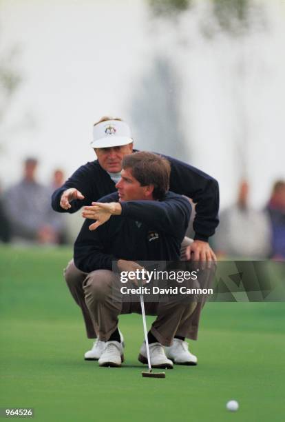 Fred Couples and Ray Floyd of the USA team line up an important putt during the Ryder Cup at the Belfry in Sutton Coldfield in England. \ Mandatory...