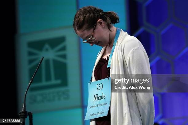 Nicole Tsygan of Monkton, Maryland, tries to spell her word during round four of the 91st Scripps National Spelling Bee at the Gaylord National...