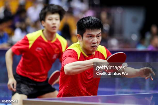 Fan Zhendong and Lin Gaoyuan of China in action at the men's doubles match compete with Lam Siu Hang and Ng Pak Nam of Hong Kong China during the...