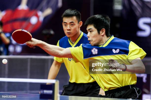 Chen Chien-An and Chuang Chih-Yuan of Chinese Taipei in action at the men's doubles match compete with Ma Long and Xu Xin of China during the 2018...