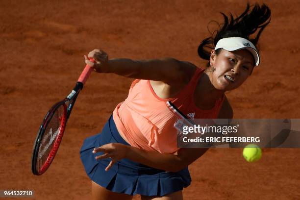 China's Peng Shuai serves to France's Caroline Garcia during their women's singles second round match on day five of The Roland Garros 2018 French...