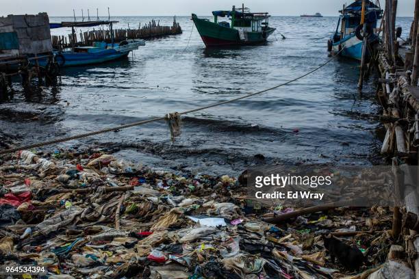 Plastic trash left behind by the tide mars the beach of a fishing village on the northern coast on May 31, 2018 in Jakarta, Indonesia. Indonesia has...