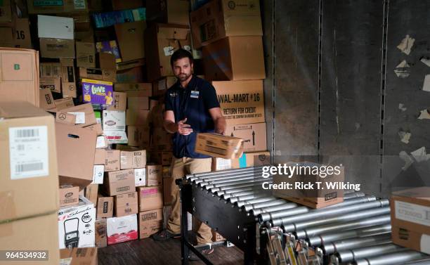 Walmart associate unloads a truck at a Walmart Supercenter during the annual shareholders meeting event on May 31, 2018 in Rogers, Arkansas. The...