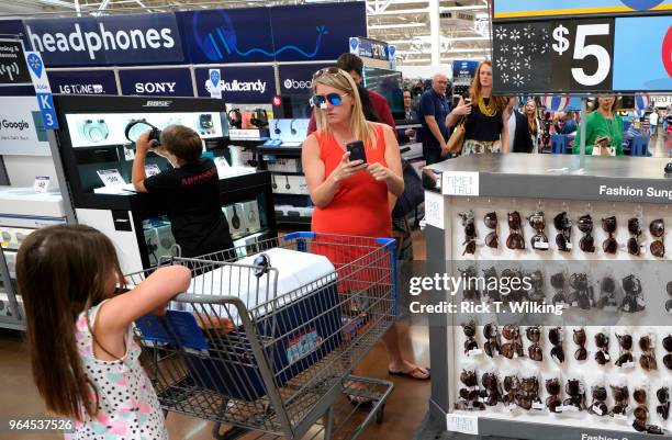 Customer tries on $5 sunglasses at a Walmart Supercenter during the annual shareholders meeting event on May 31, 2018 in Rogers, Arkansas. The...