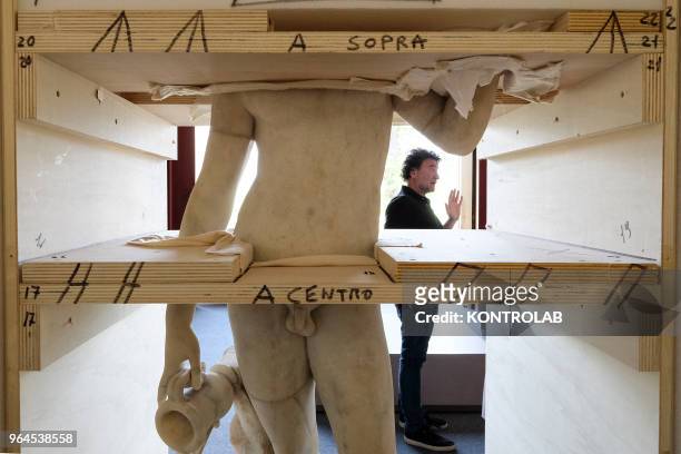 Specialists work to set up the exhibition 'L'Immagine Invisibile" at Archeological Museum in Paestum southern Italy. The exhibition shows paintings,...