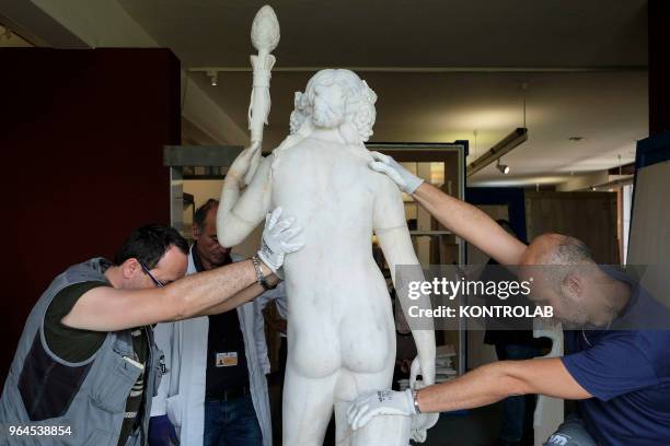 Specialists work to set up the exhibition 'L'Immagine Invisibile" at Archeological Museum in Paestum southern Italy. The exhibition shows paintings,...