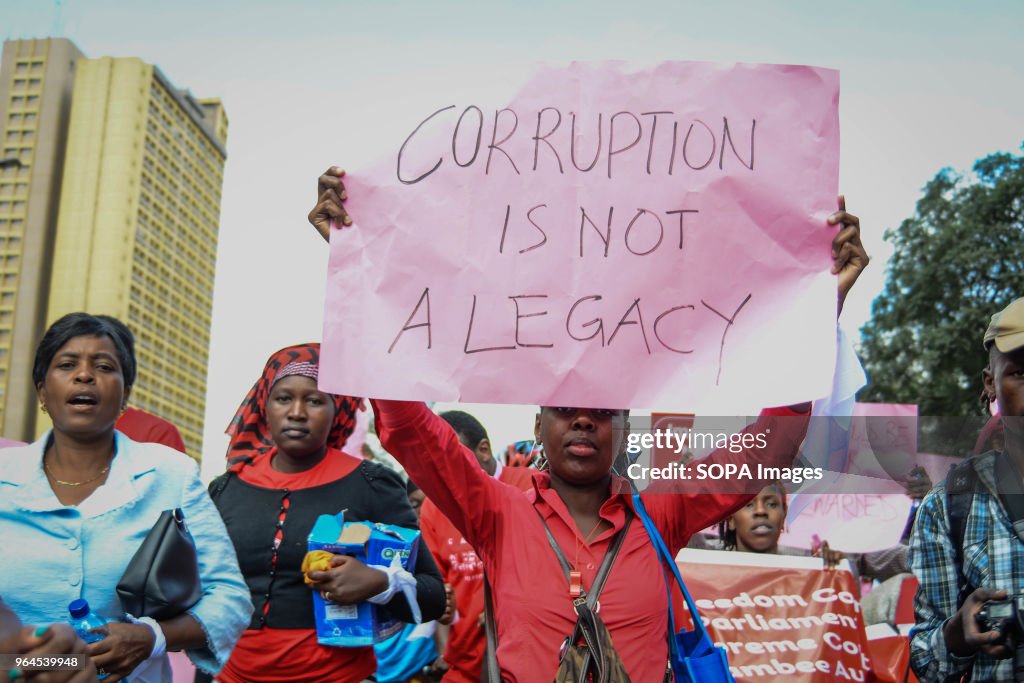 A protestor carries a placard as Kenyans protested in the...