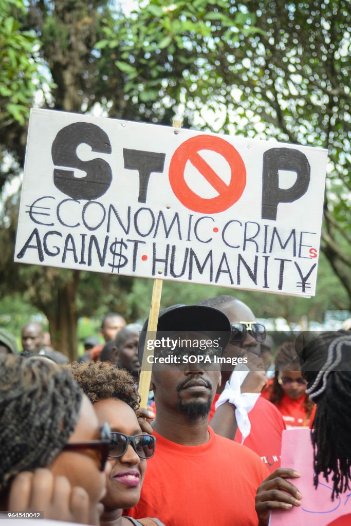 A protestor carries a placard as Kenyans protested in the...