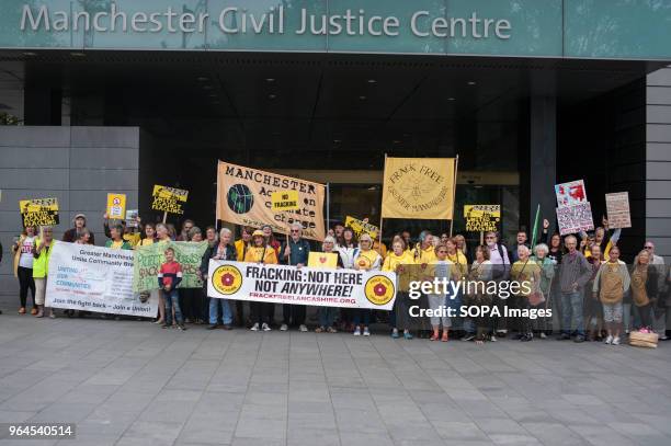 Protesters seen holding banners and placards during the protest. Demonstration outside the Manchester Civil Justice Centre to campaign against the...