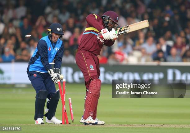 Chris Gayle of West Indies is bowled by Shoaib Malik of the ICC World XI as wicket-keeper Luke Ronchi of the ICC World XI looks on during the...