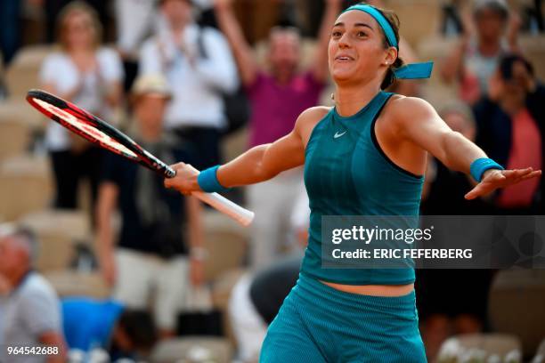 France's Caroline Garcia celebrates after victory over China's Peng Shuai during their women's singles second round match on day five of The Roland...