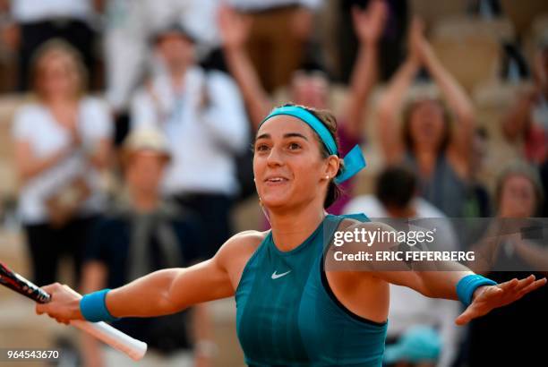 France's Caroline Garcia celebrates after victory over China's Peng Shuai during their women's singles second round match on day five of The Roland...