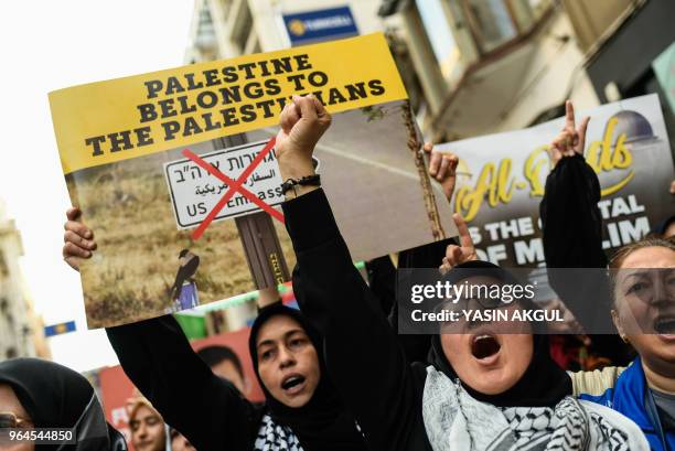 Demonstrators chant slogans and raise their fist on May 31, 2018 at Istiklal avenue in Istanbul, during a march to mark the 8th anniversary of a...