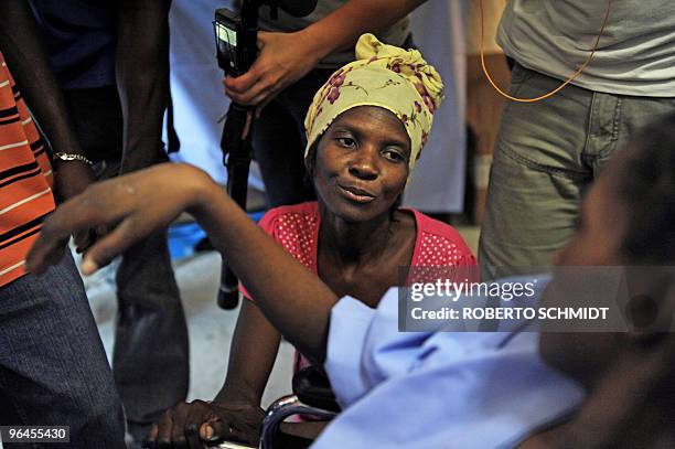 Karlene Etienne the mother of sixteen-year-old Darlene the last survivor to be found alive in the rubble by rescuers looks at her daughter after...