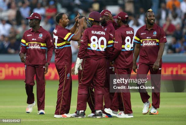 Samuel Badree of West Indies celebrates dissmissing Dinesh Karthik of the ICC World XI with his team mates during the Hurricane Relief T20 match...