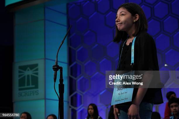 Melodie Loya of Oneonta, New York tries to spell her word during round six of the 91st Scripps National Spelling Bee at the Gaylord National Resort...