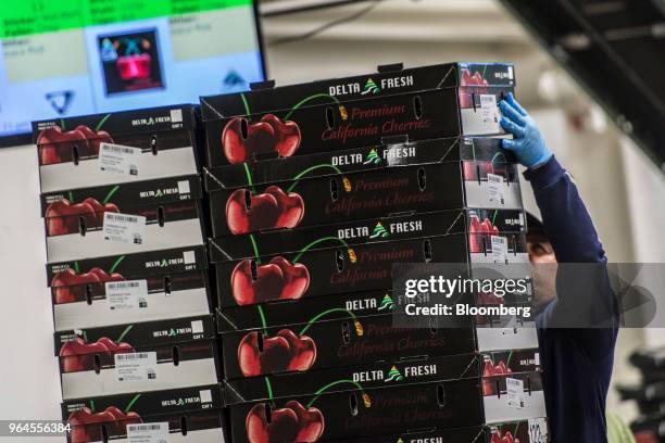 Worker stacks boxes of cherries to be shipped out at the Delta Packing Co. Of Lodi Inc. In Lodi, California, U.S., on Tuesday, May 29, 2018. Renewed...