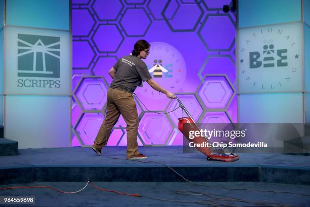 The stage is vaccumed in between sessions of the final day of the 91st Scripps National Spelling Bee at the Gaylord National Resort and Convention...