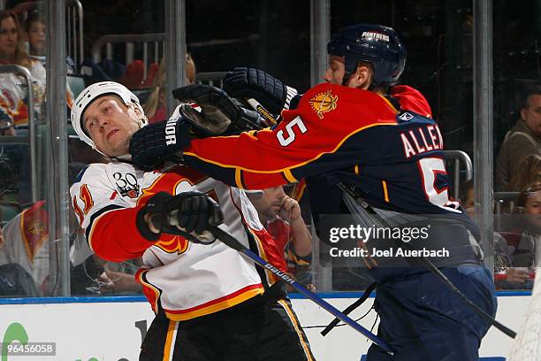 Bryan Allen of the Florida Panthers and Niklas Hagman of the Calgary Flames fight behind the net on February 5, 2010 at the BankAtlantic Center in...