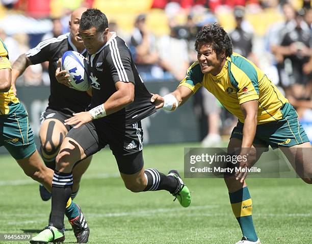 Sherwin Stowers of New Zealand is tackled by Brian Sefanaia of Australia in the Quarter Final Cup match between New Zealand and Australia during day...