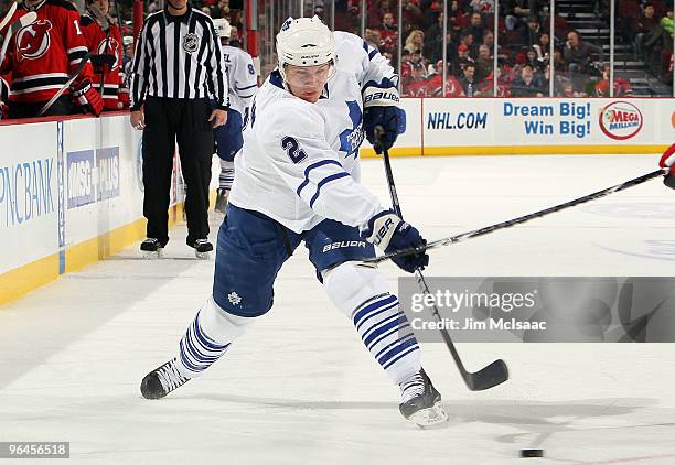 Luke Schenn of the Toronto Maple Leafs shoots the puck against the New Jersey Devils at the Prudential Center on February 5, 2010 in Newark, New...