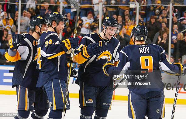 Drew Stafford of the Buffalo Sabres celebrates his second goal of the game against the Carolina Hurricanes with teammates Andrej Sekera, Chris...