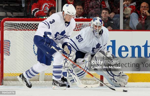 Dion Phaneuf and Jonas Gustavsson of the Toronto Maple Leafs defend the net against the New Jersey Devils at the Prudential Center on February 5,...