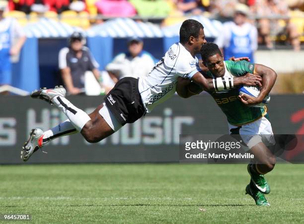 Branco Du Preez of South Africa is tackled by Jiuta Lutumailagi of Fiji in the Quarter Final Cup match between Fiji and South Africa during day two...