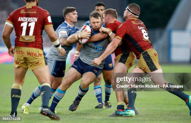 Huddersfield Giants' Paul Clough is tackled by Catalan Dragons' Michael McIlrum and Remi Casty during the Ladbrokes Challenge Cup, quarter final...