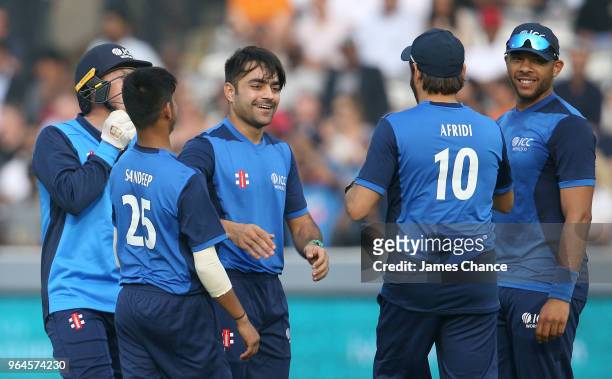 Rashid Khan of the ICC World XI celebrates dissmissing Evin Lewis of the West Indies for LWB with his team mates during the Hurricane Relief T20...