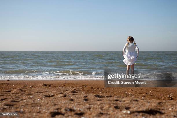 young girl on beach - oostende stockfoto's en -beelden